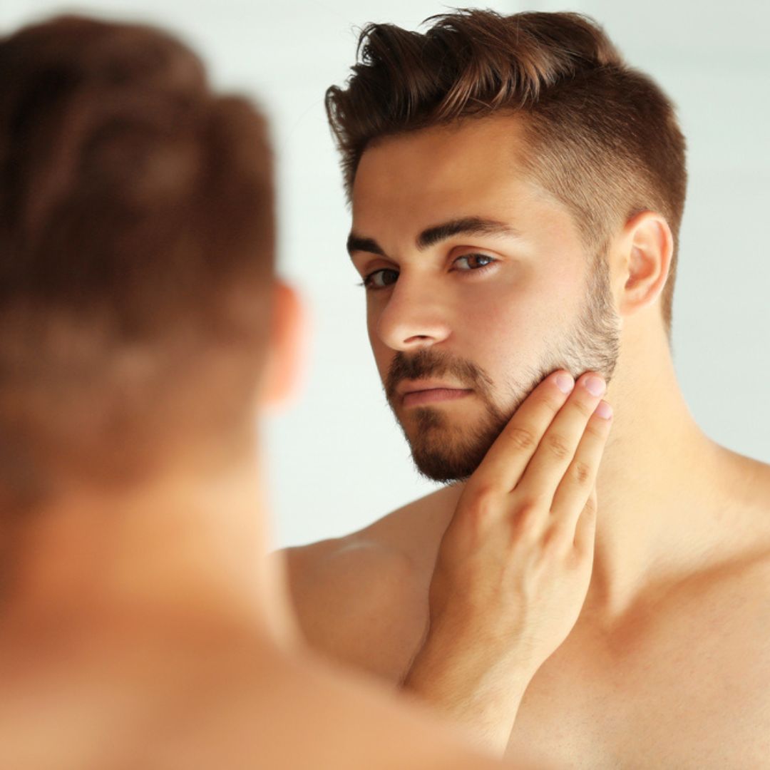 man looking in mirror