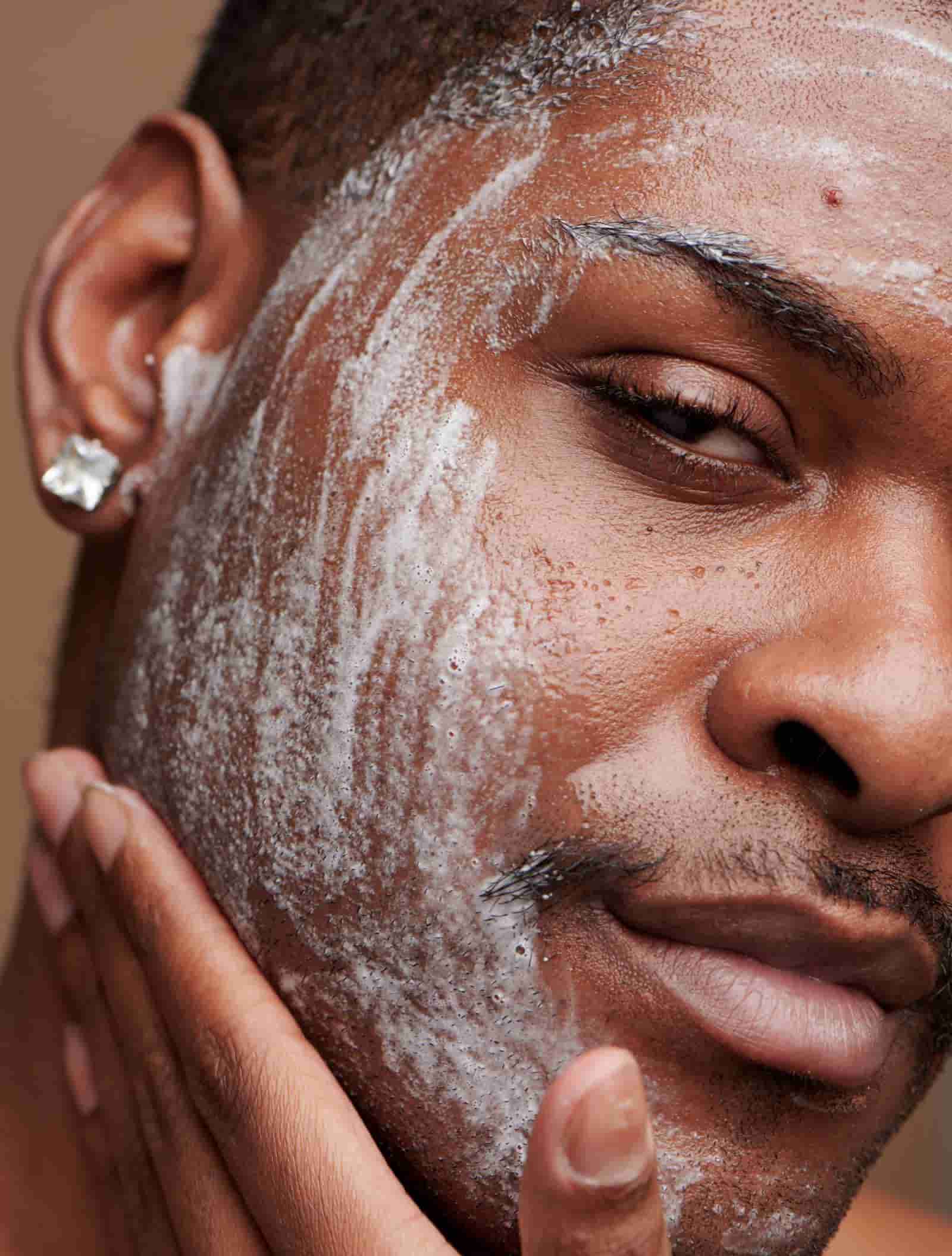 man cleansing face