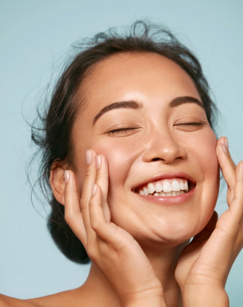 woman smiling with blue background