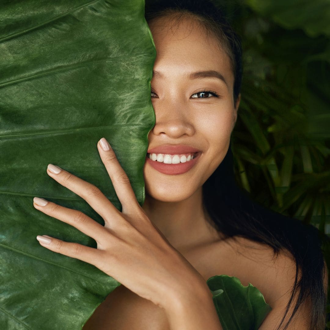 woman with foliage smling