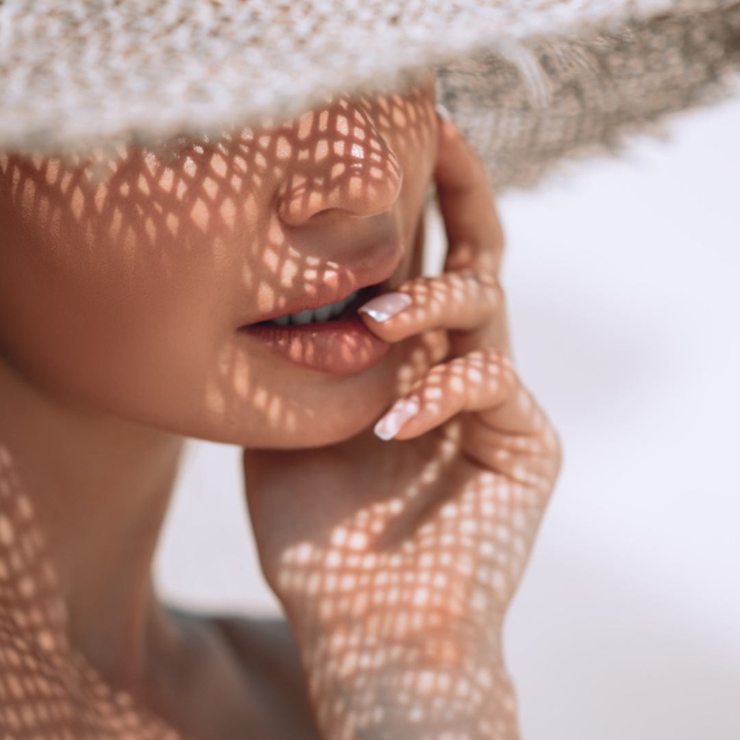 woman with beautiful lips wearing a straw hat