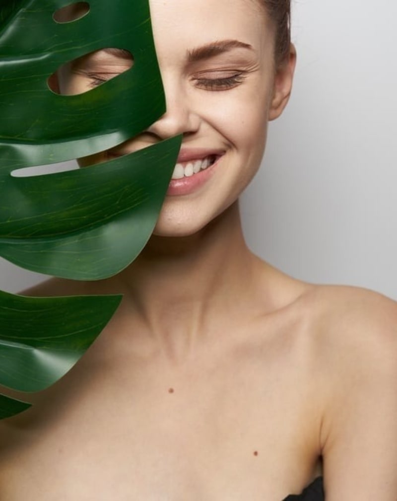 woman holding palm leaf