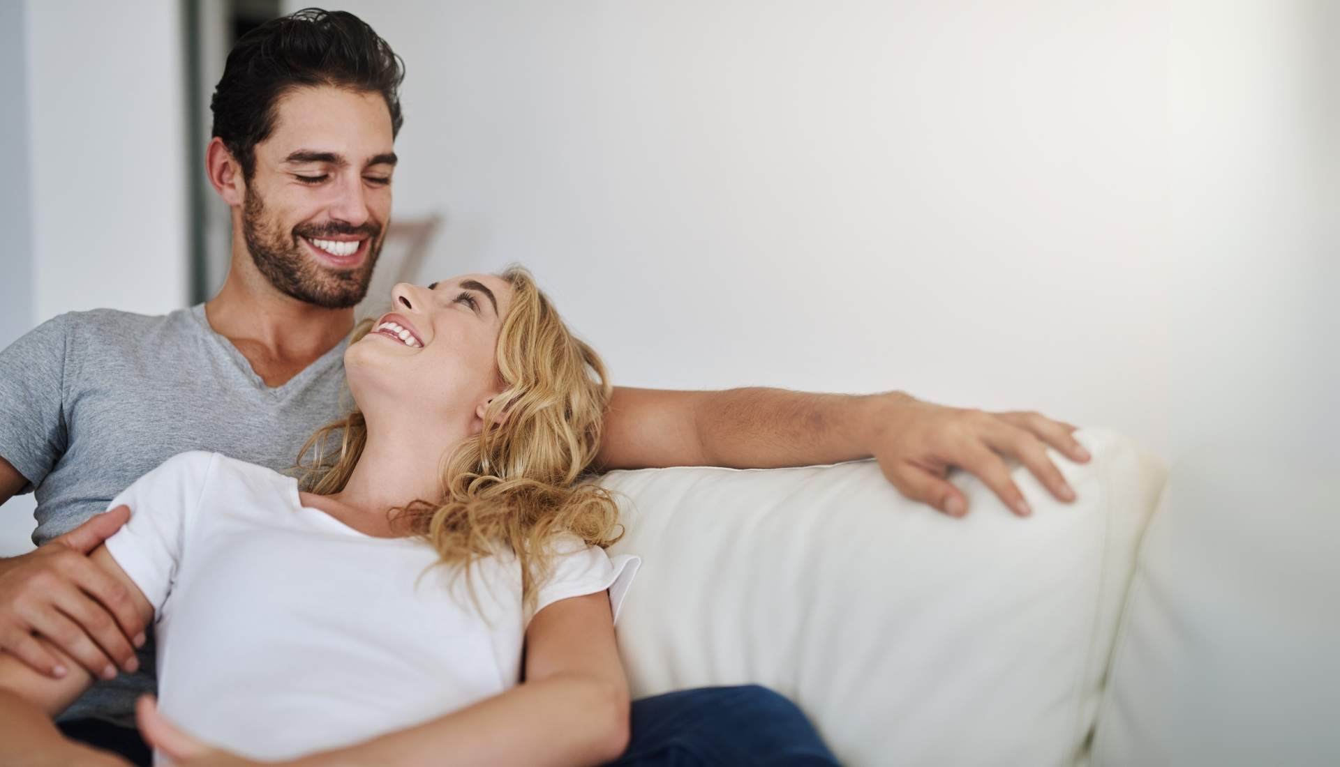 happy couple sitting on couch